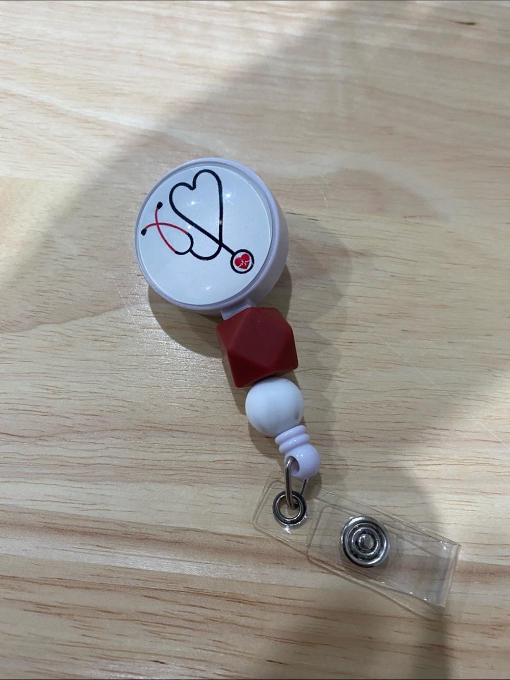 White Badge Reel with Heart Stethoscope Design and Red Beads